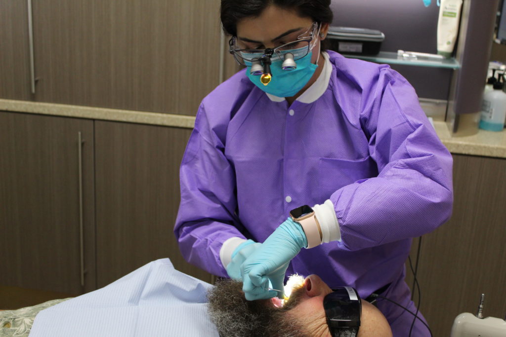 dental hygienist with patient